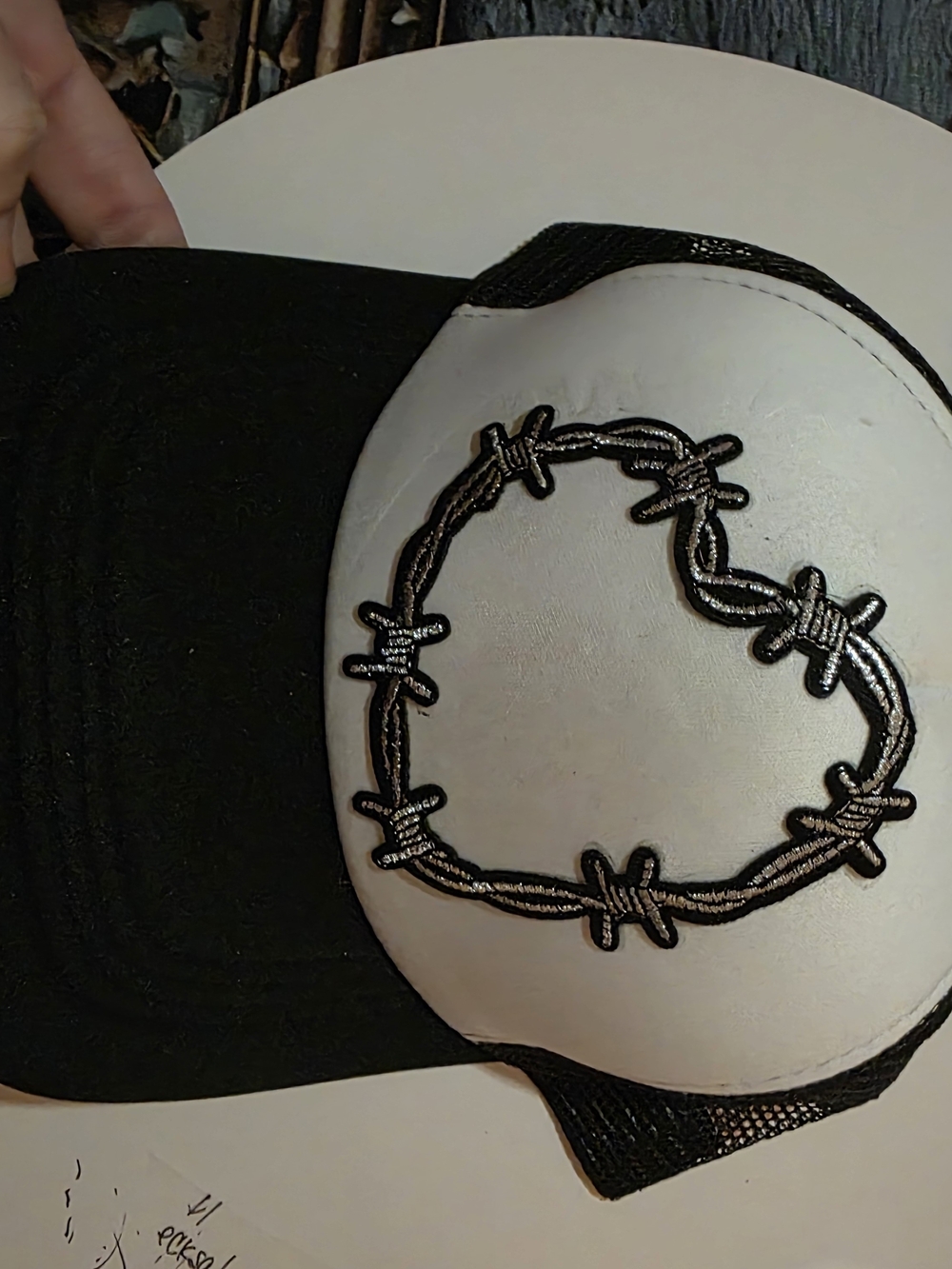 Womenβs Black and White Trucker Hat with Heart Barbed Wire Patch